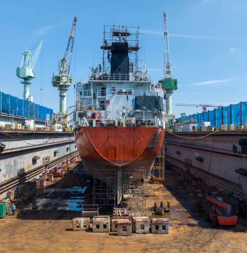 Oil tanker ship at dry dock concept maintenance service. working at dry dock. Insurance and Maintenance Crude tanker Ship concept. Freight Forwarding Service maintenance Insurance