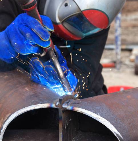 Welding work, welder welding metal material in heavy industry manufacturing, video clip
